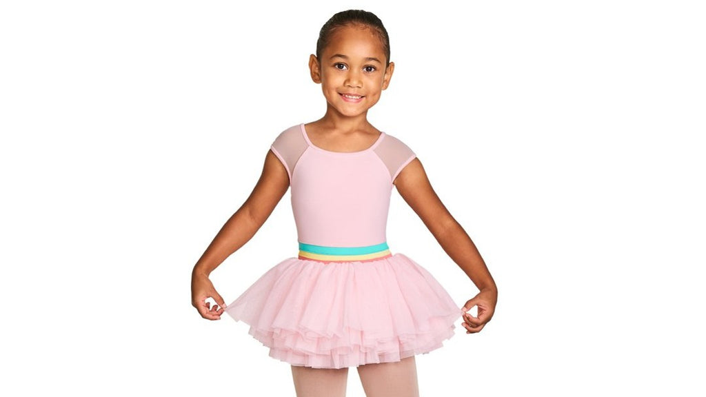 A young ballet dancer wearing the Mabel Mabel cap sleeve tutu leotard in candy pink with tights