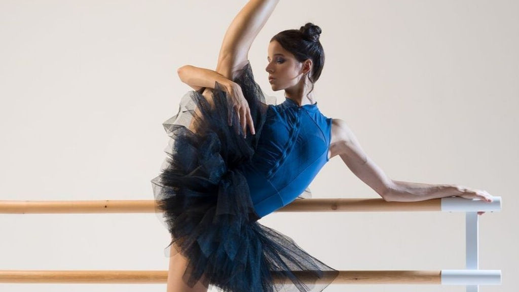 Ballet dancer Maria Khoreva dancing at the barre in blue BLOCH high neckline tank leotard and black tutu