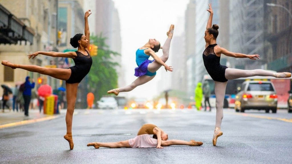A group of young ballet dancers dancing through the streets of New York