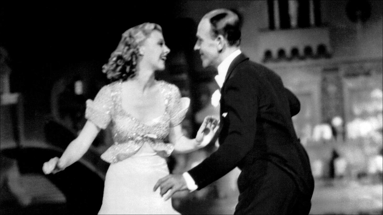 A male and female dancer tap dancing together on stage 