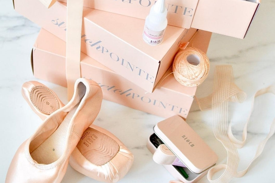 BLOCH Pointe Shoes Accessories in small tin next to a pair of pointe shoes